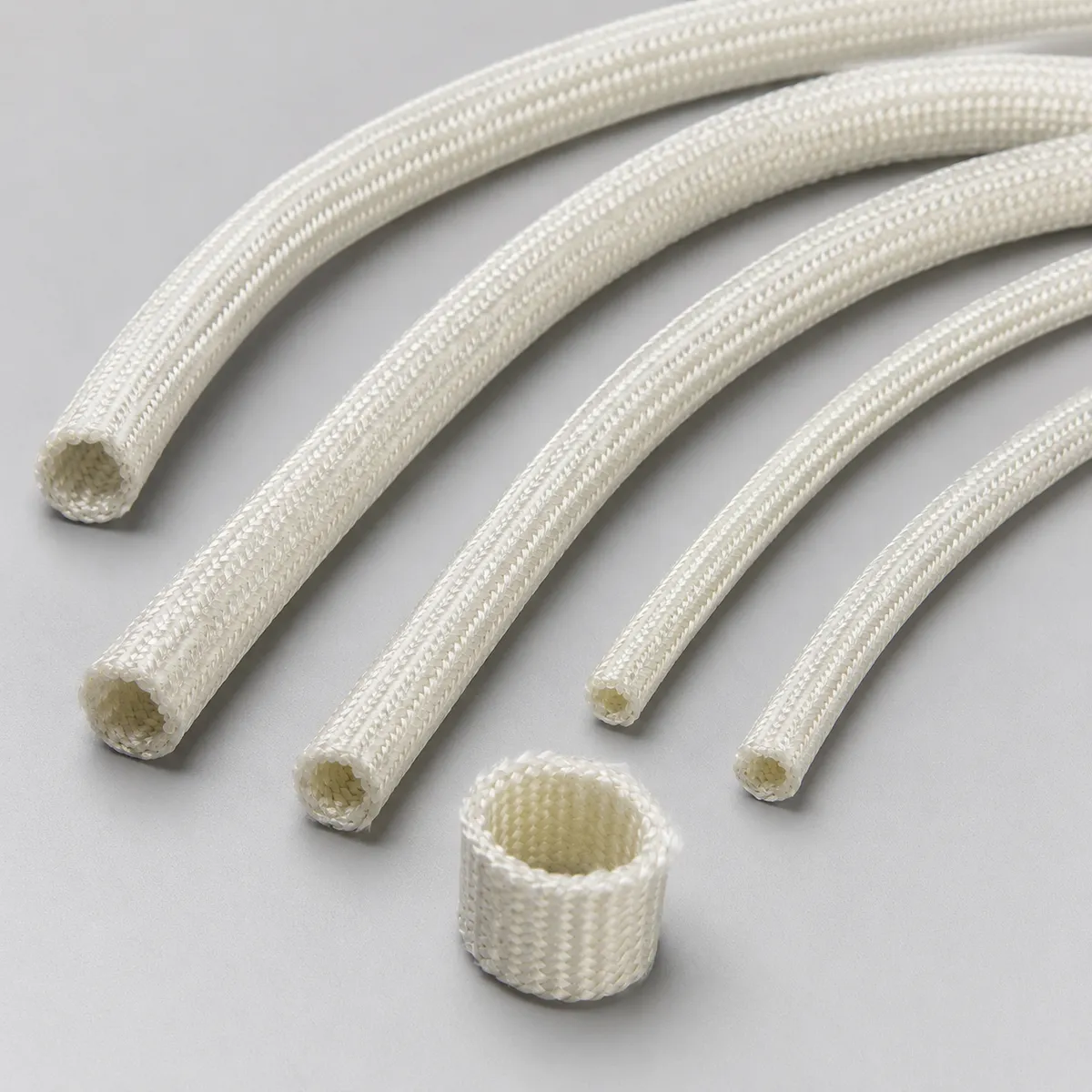 Natural white braided fiberglass insulation sleeves in multiple diameters
