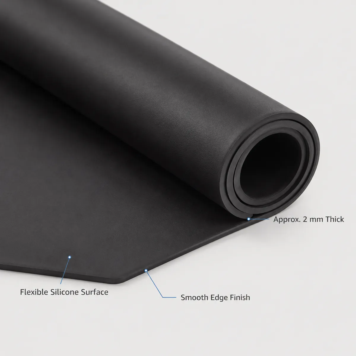 Close-up of rolled black silicone mat showing flexible surface and smooth edge finish