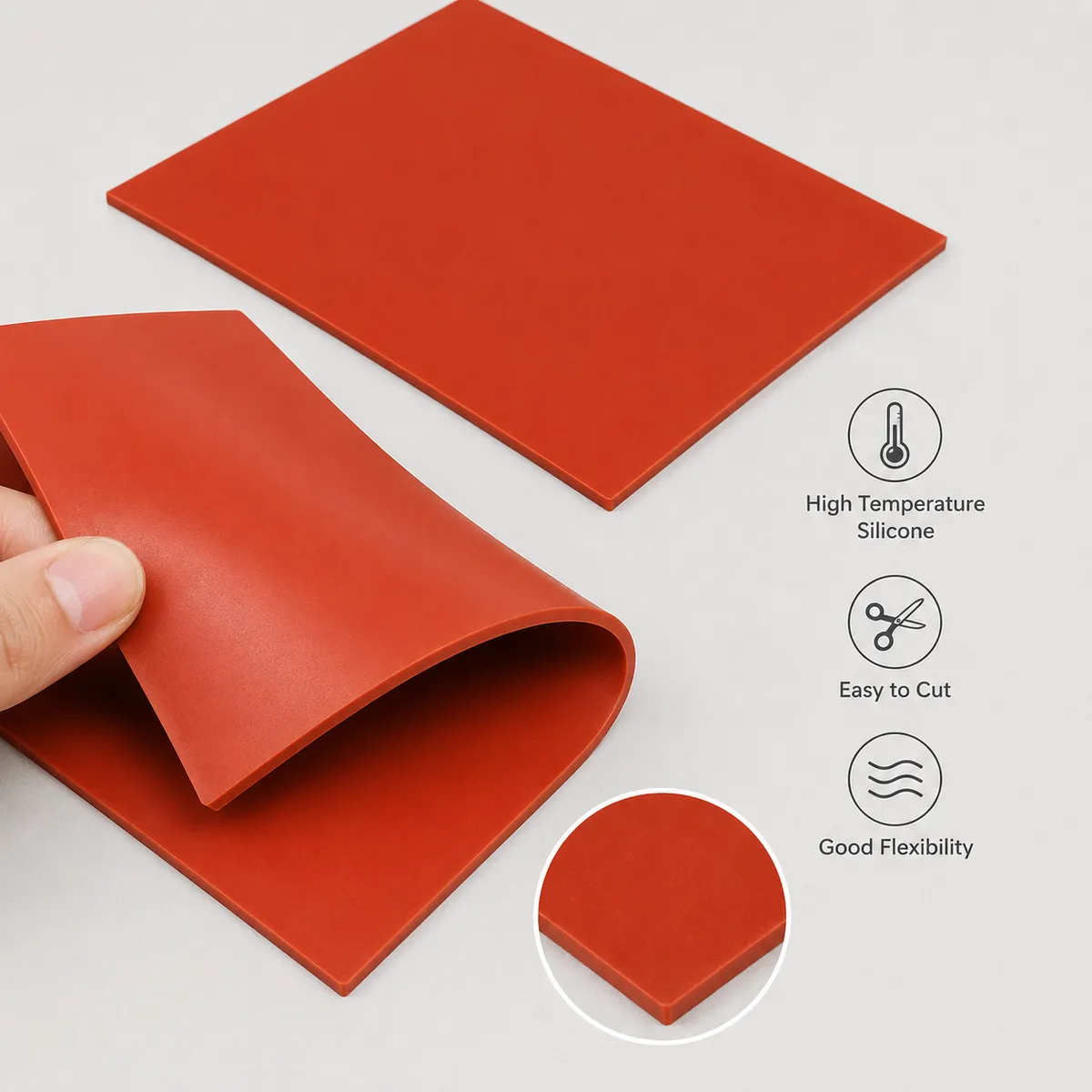 Flexible red silicone sheet bent by hand with material feature callouts