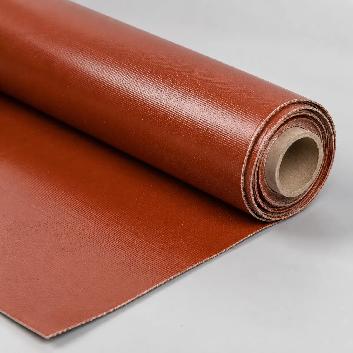 Silicone coated fiberglass fabric roll on light gray background