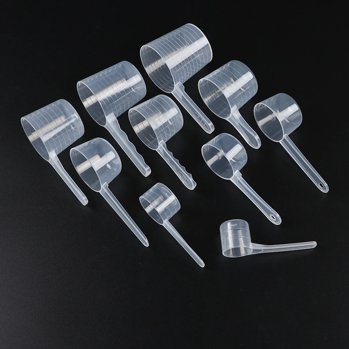 Assortment of translucent PP graduated scoops in several cylindrical cup sizes